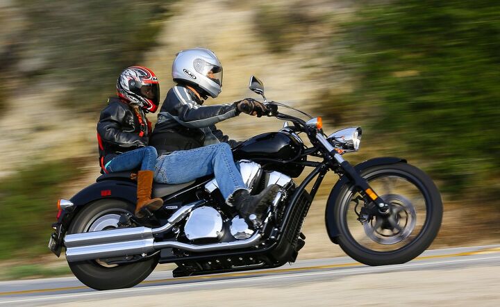 kid riding motorcycle with dad